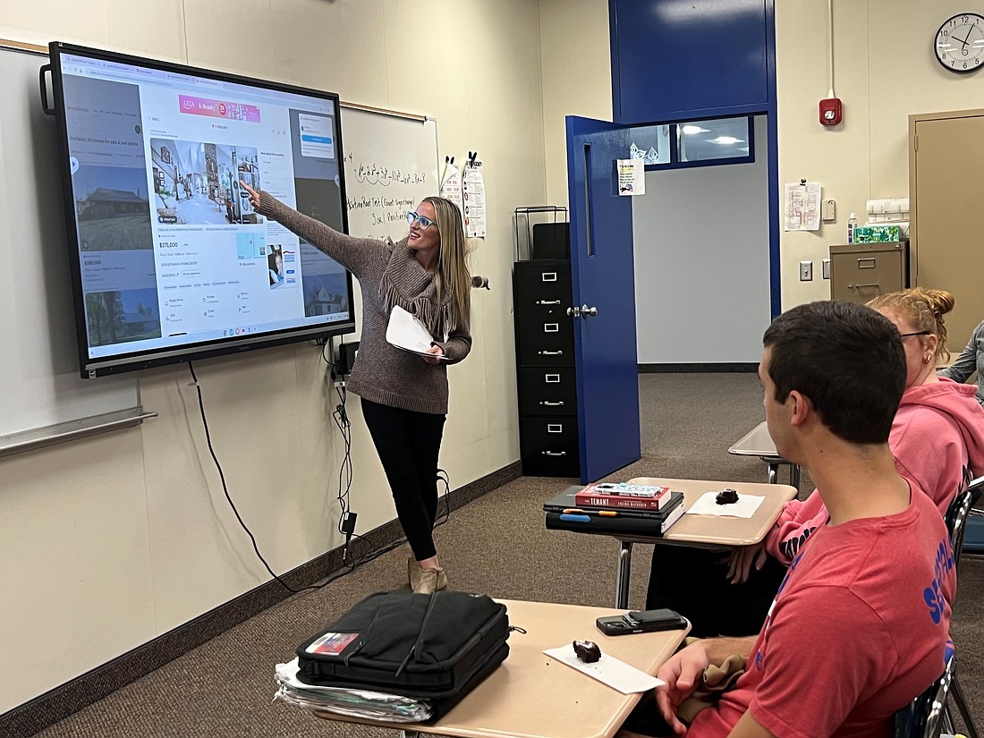 Last month, First Bank of Berne partnered with Jay County Junior-Senior High School for financial education. Bank employees visited the school to teach seniors about financial concepts including interest, amortization and the importance of saving money. Pictured, First Bank of Berne mortgage loan originator Tanner McClain shares a lesson with students. (photo provided)