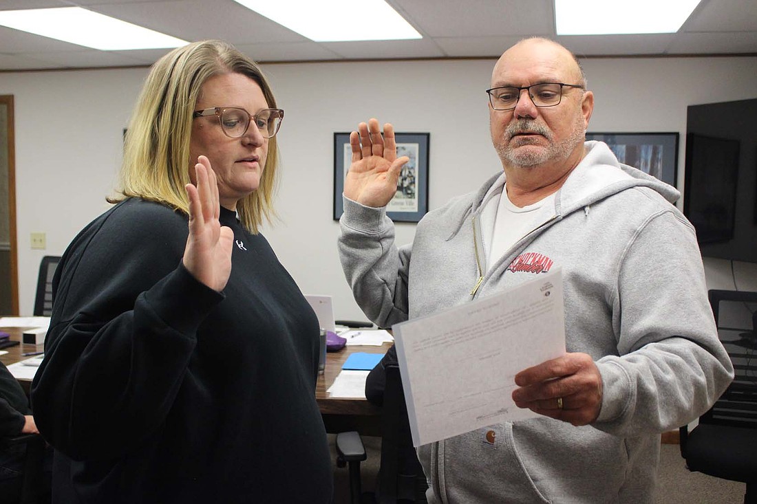 Fort Recovery Mayor Dave Kaup (right) swears in Amy Wendel as a new member of Fort Recovery Village Council during Monday’s meetings. Shawn Thobe and Wendel were chosen by the council to fill two seats that remained empty following November’s general election. (The Commercial Review/Bailey Cline)