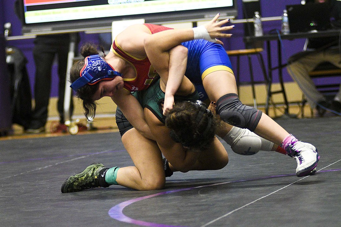 Katie Rowles of Jay County High School twists Eastern (Greentown) senior Nichole Smith in her regional quarterfinal match Saturday at Muncie Central. Her quick pin of Smith secured her a state berth in the 100-pound weight class. Rowles is the only Patriot headed to state this year and will compete at 10 a.m. Friday at Corteva Coliseum in Indianapolis. (The Commercial Review/Ray Cooney)