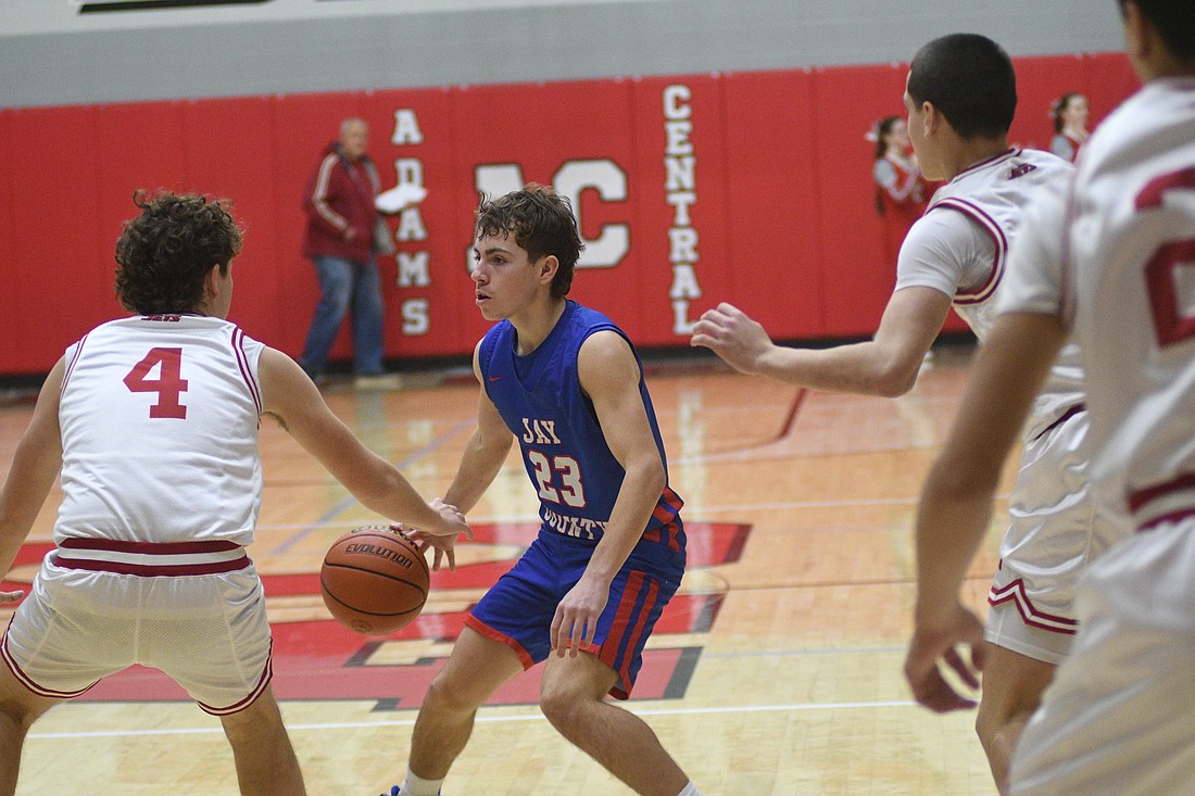 Samuel Wiggins of the Jay County High School boys basketball team handles the ball during the Patriots’ 74-53 road win over the Adams Central Flying Jets on Saturday. The result continued streaks for both teams, as the Patriots have now won five straight games while Adams Central has dropped five in a row. (The Commercial Review/Ray Cooney)