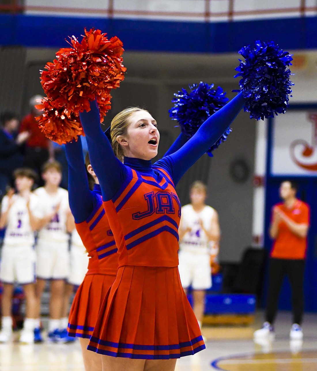 Jay County High School cheerleader Faith Faulkner chants in front of the crowd following the Patriots’ 50-20 victory over Woodlan’s girls basketball team on Tuesday evening. Both the boys and girls basketball teams beat Woodlan by 30 or more points to advance to Friday’s semifinal against Southern Wells. (The Commercial Review/Andrew Balko)