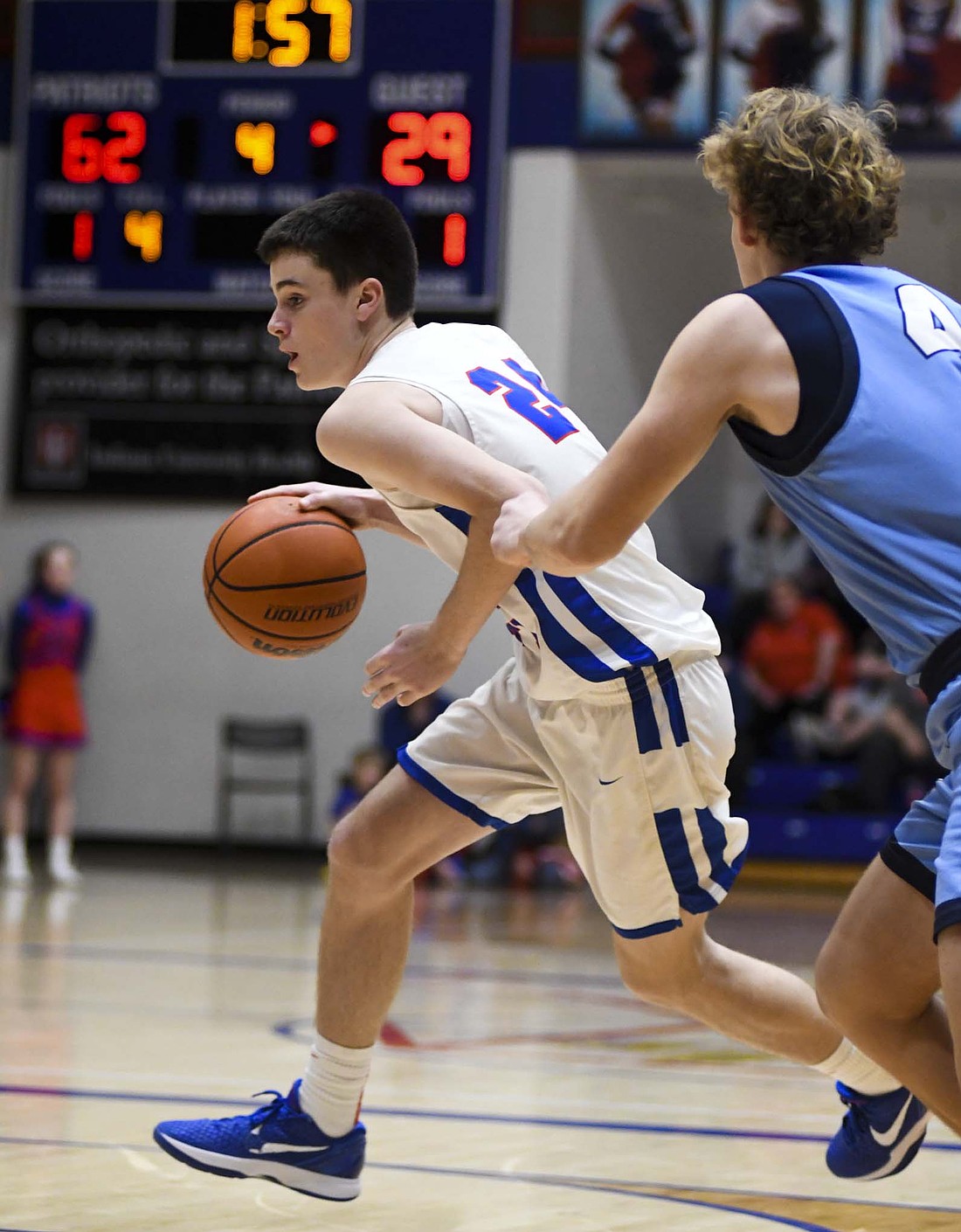 Alex Miller of Jay County drives past one of Woodlan’s starters, Camden Brooks, in the closing minutes of the Patriots’ 65-29 victory on Tuesday. The win advanced Jay County to Friday’s ACAC semifinal against Southern Wells, which holds a 1-7 record. (The Commercial Review/Andrew Balko)