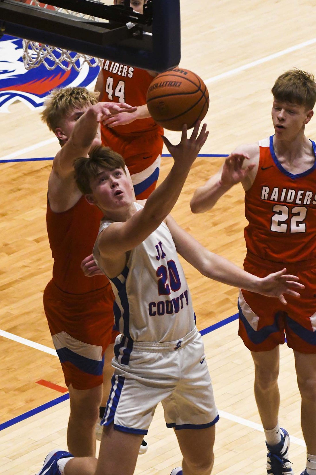 Brock Wasson of the Jay County High School boys basketball team goes up for a reverse layup to avoid the block attempt of Southern Wells' Joshua Aulbach during Friday night’s Allen County Athletic Confernece tournament semifinal. Wasson scored 11 points and dished out two assists to help power the Patriots to a 60-19 victory. JCHS will take on Heritage tonight in the ACAC championship game at South Adams. (The Commercial Review/Andrew Balko)