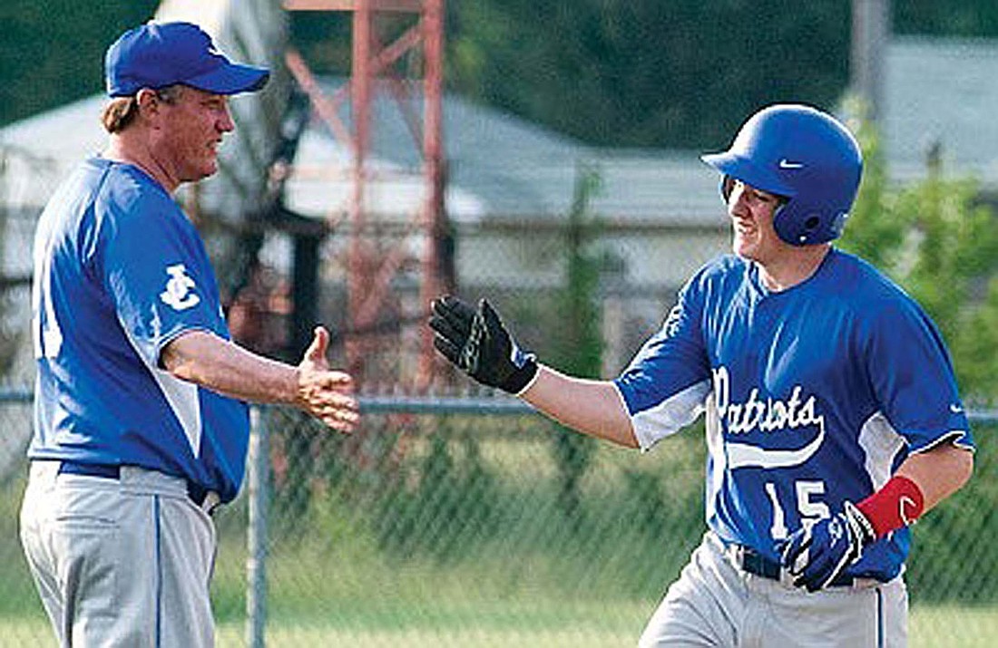 Lea Selvey high fives Toby McCallister while rounding third base following a two-run home run to lift Jay County to an 11-7 win over Bluffton to close the 2013 regular season. Selvey is being inducted to the Indiana Baseball Hall of Fame on Friday for his 34 years spent as the Patriots head coach. He led JCHS to three regional titles, seven sectionals and is the winningest baseball coach in school history at 526-351. (The Commercial Review/Ray Cooney)
