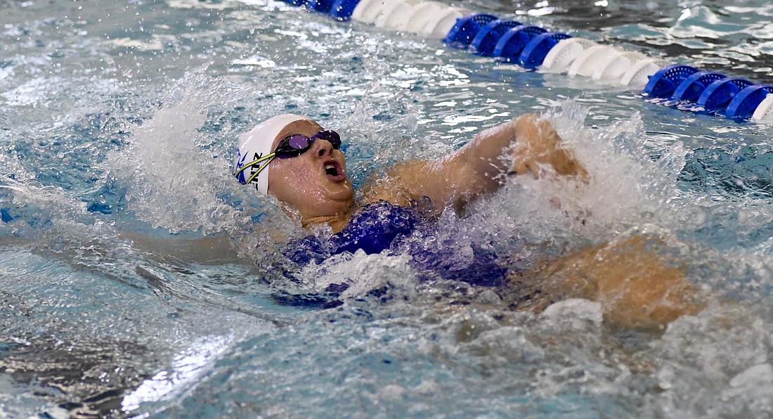 Avery Wentz of the Jay County High School swim team backstrokes onward during Saturday’s Allen County Athletic Conference meet. The Jay County girls scored 452 points to claim the conference crown. (The Commercial Review/Andrew Balko)