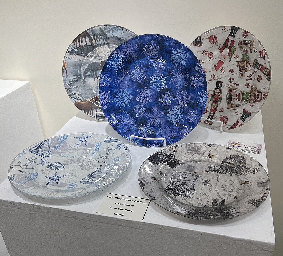 The Jay County Campus of Arts Place is featuring its first Staff & Family Show in the Weaver Community Gallery. The show includes pieces from visual arts director Allison Smiley of Ridgeville, head receptionist Teresa Penrod of Portland and staff members’ spouses and children. Pictured is a display of decorative plates made by Penrod, who attends six craft shows each year. (The Commercial Review/Ray Cooney)
