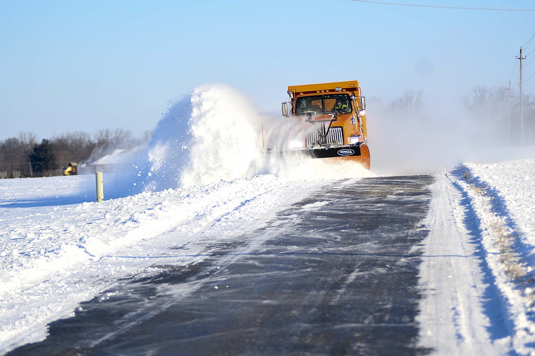 A Jay County Highway Department plow clears snow from the west side of Blaine Pike between county road 200 South and Deer Haven Drive. Jay County was the only of the state’s 92 county’s under a travel warning this morning before shifting back to a watch at 10 a.m. Blowing snow continued to be a challenge as county crews tried to keep roads clear. (The Commercial Review/Ray Cooney)