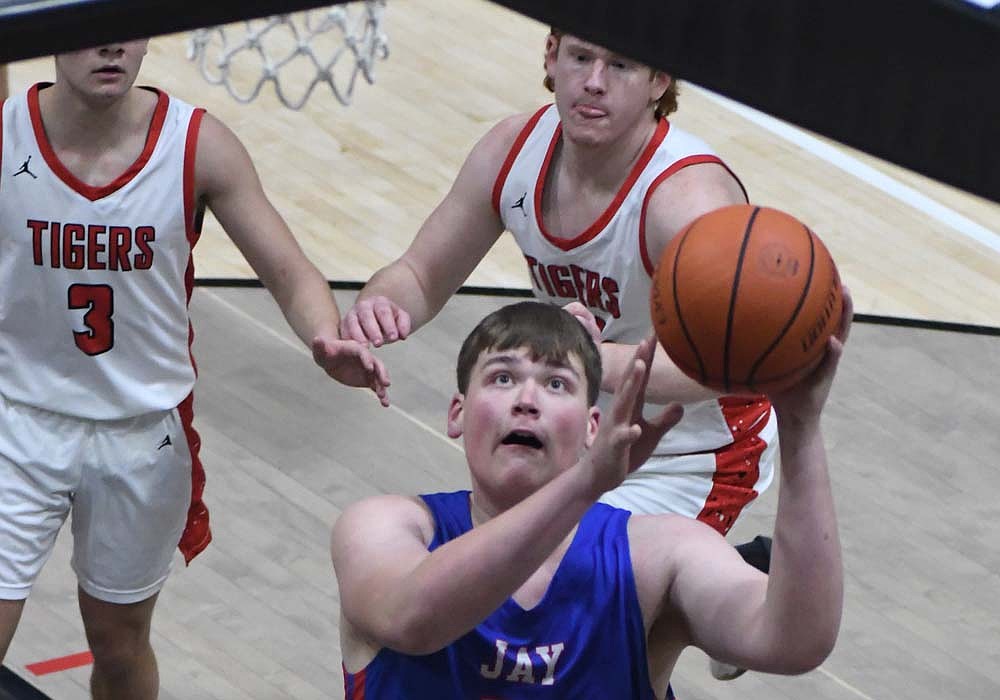Kade Sommers of the Jay County High School boys basketball team goes up for a wide-open layup off a pass from Jayden Comer during the Patriots' 47-39 victory over Bluffton on Friday. Sommers played a key role in the late offense for the Patriots as he set a pair of screens to get Comer open beyond the arc to help pull away in the fourth quarter. (The Commercial Review/Andrew Balko)